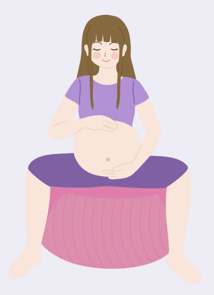 pregnant woman sitting on exercise ball